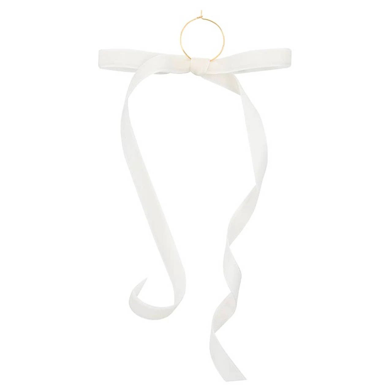 White velvet bow with a small gold ring charm at the top and curling ribbon tails.