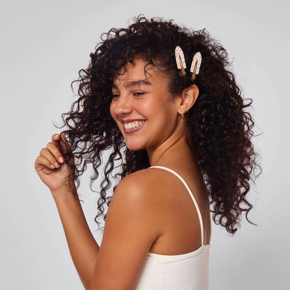 Recycled plastic creaseless hair clips 4pc set in cherry print, two clips worn in model's hair
