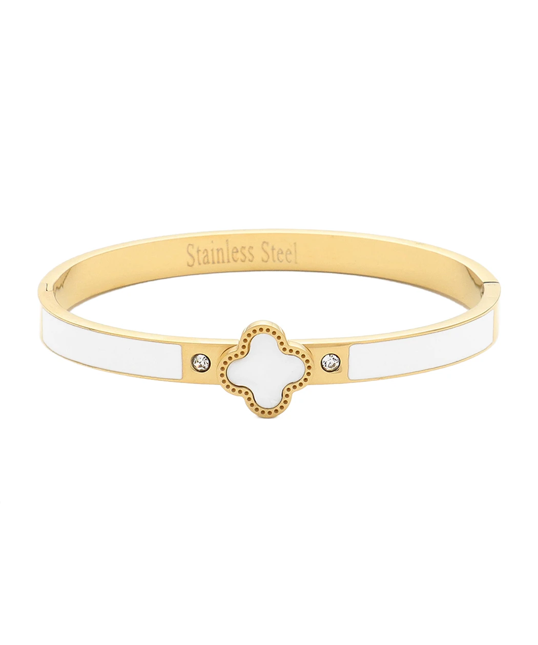 Gold-tone enamel clover bangle with white enamel panels and a dotted-edge clover charm, flanked by two crystals.
