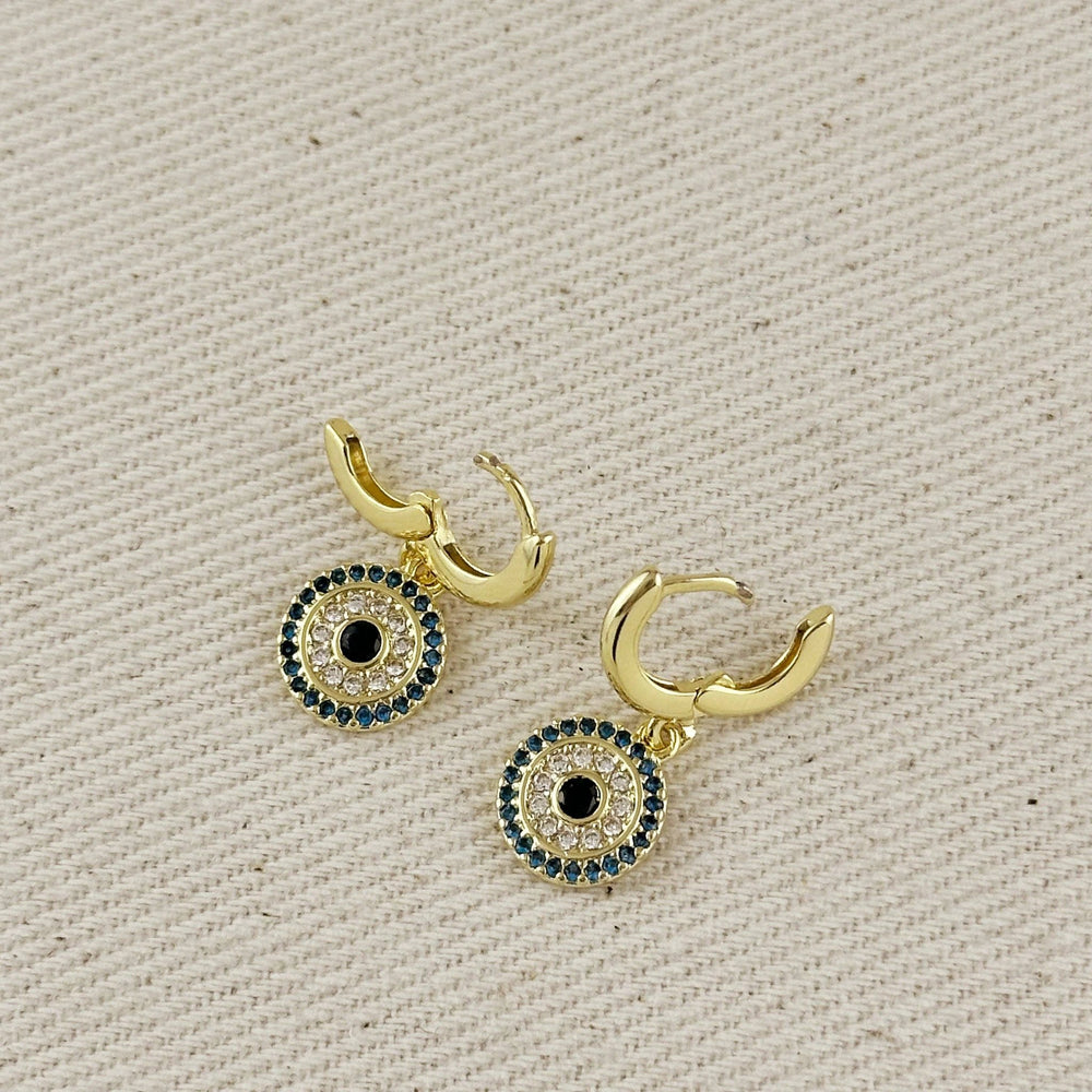 Pair of 18k gold-filled crescent hoop earrings with mandala charms: black center, clear crystals, and blue stones.