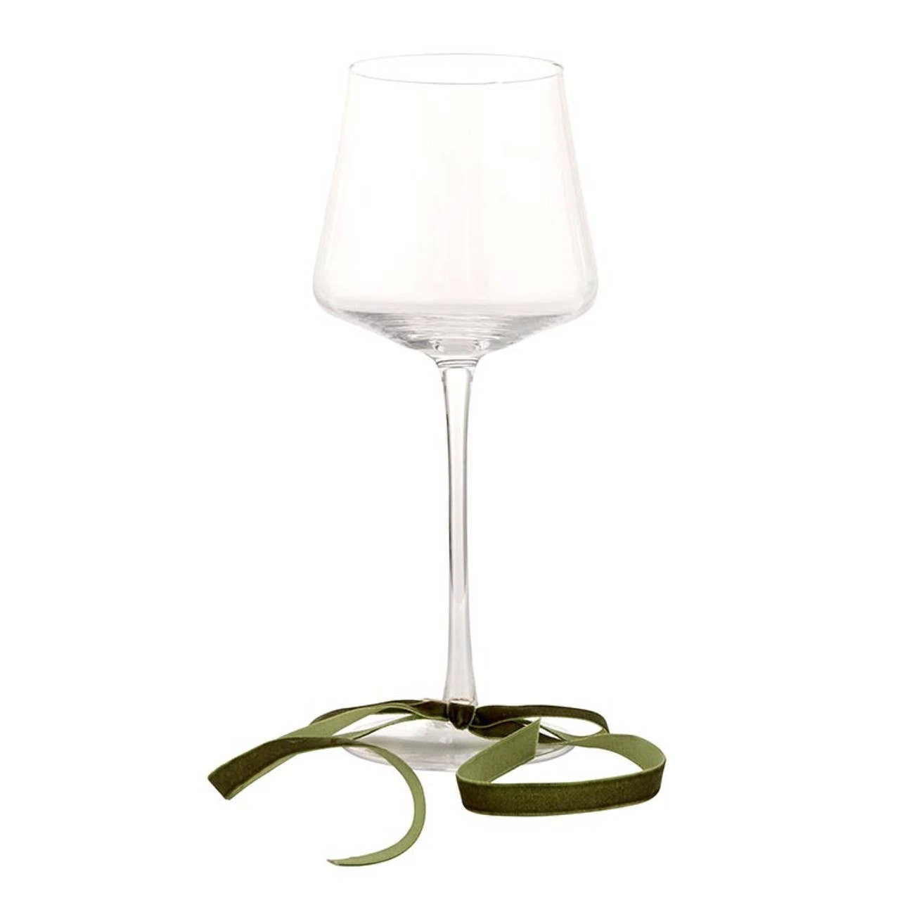Clear wine glass with a dark green velvet bow tied around the stem near the base.