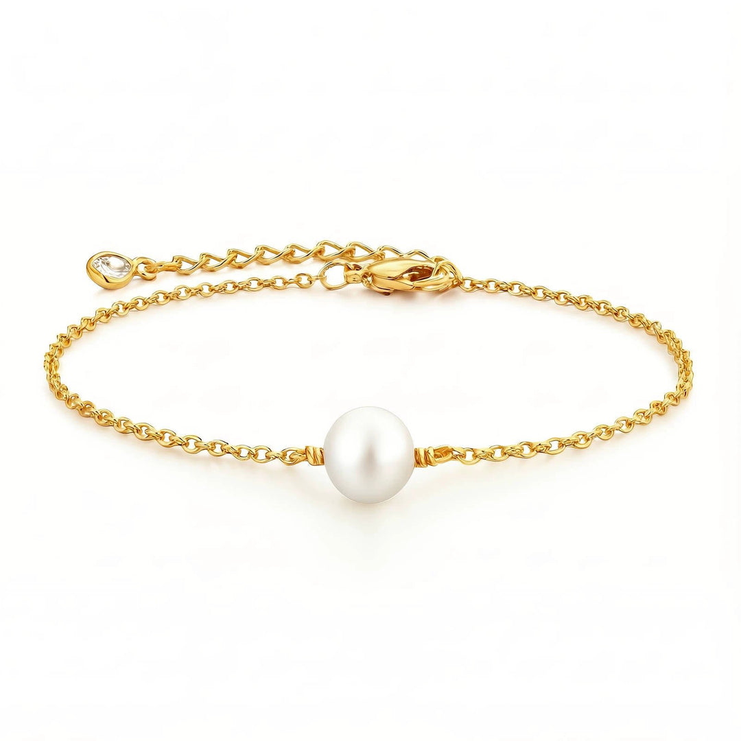 Gold-plated delicate chain bracelet with a single white pearl centerpiece and a small crystal charm at the extender.