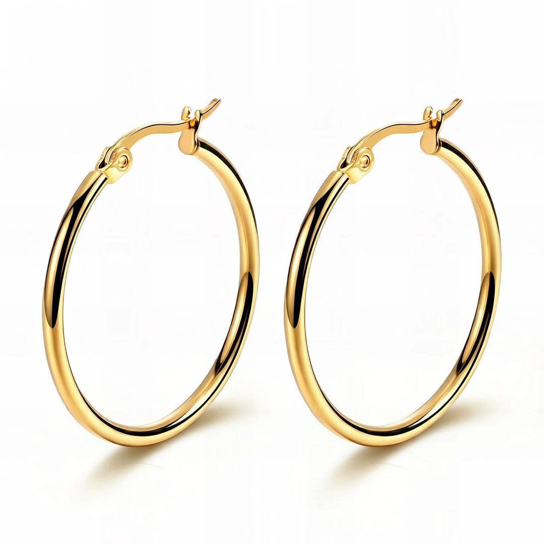 Pair of large, polished gold-tone hoop earrings with hinged clasps.