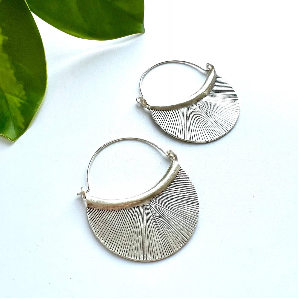 Hill Tribe sterling silver hoop earrings with etched fan-shaped petal discs and radiating lines.