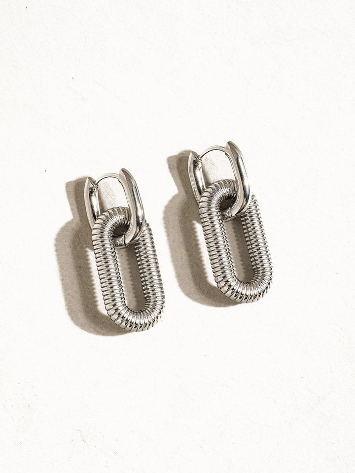 Kate 18K non-tarnish double chain hoop earrings; pair of silver ribbed oval hoops by Flânerie by MAIQ.