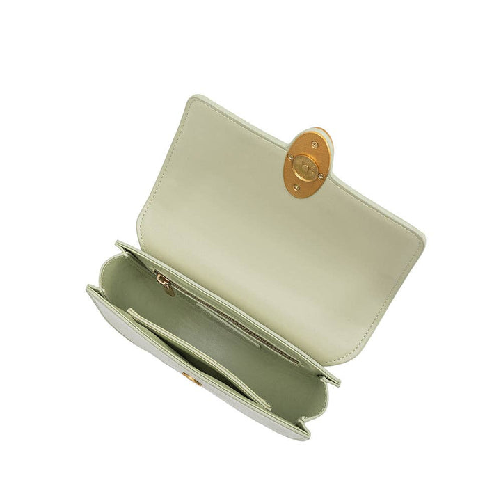 Mint green vegan leather crossbody bag opened to reveal two compartments, a zip pocket, olive interior, with gold clasp.
