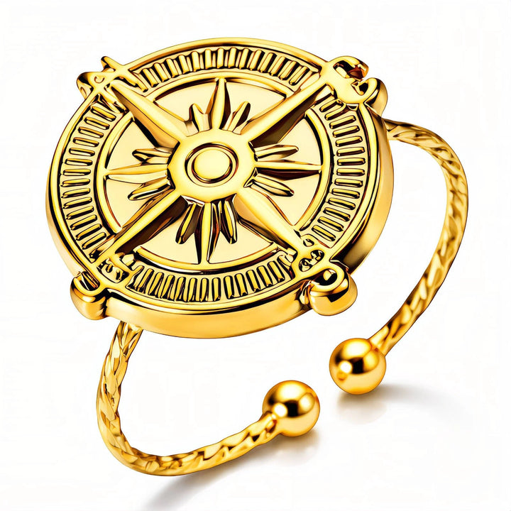 Gold-plated circular compass ring with intricate compass rose, open adjustable band, and ball-ended tips.
