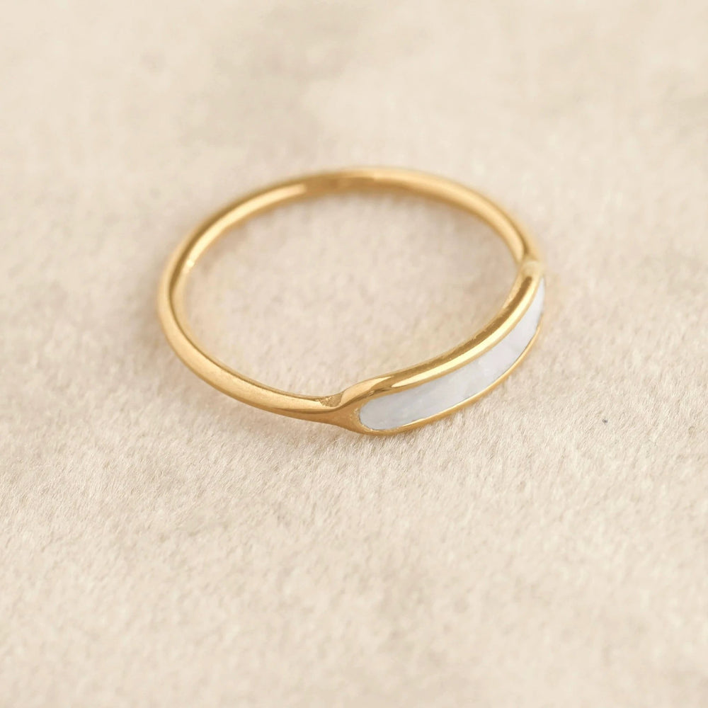 Delicate yellow-gold band ring with a white mother-of-pearl inlay along the outer surface.