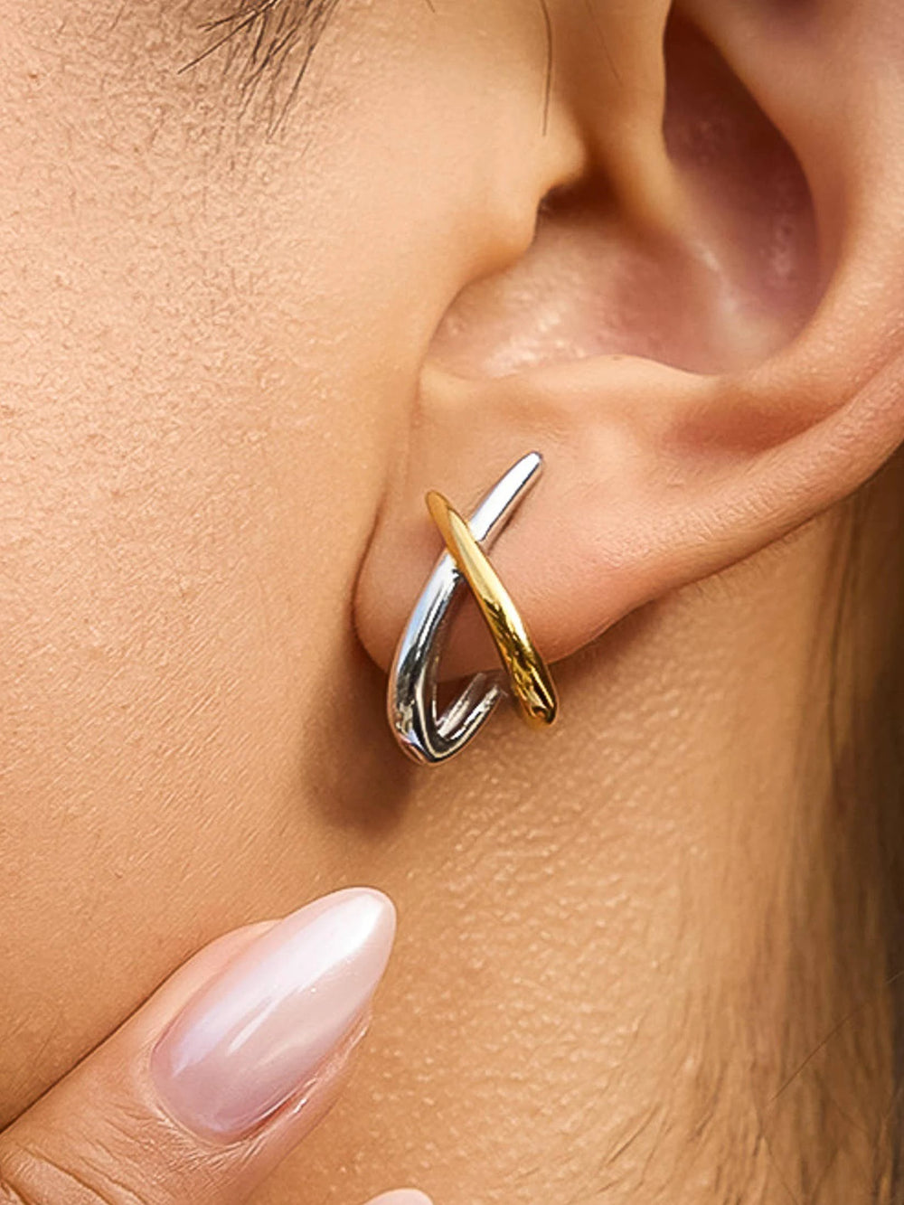 Staven two-tone crossover earrings in silver loop with a gold curved bar.