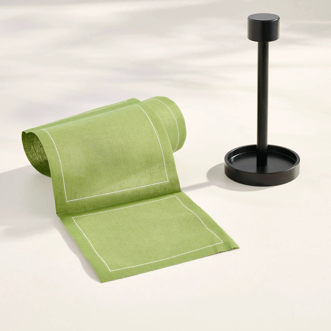 Cocktail napkin stand in matte black with lime-green napkins featuring white border lines