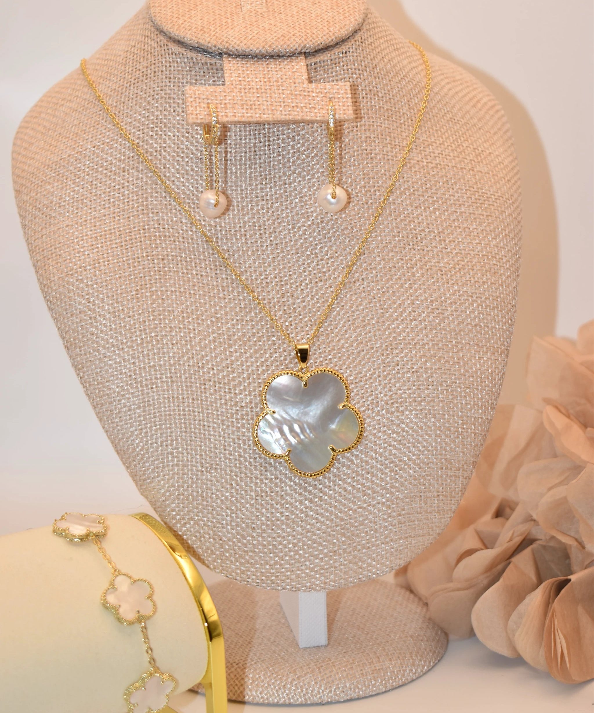 Tara Clover Necklace set: gold-tone necklace with a mother-of-pearl clover pendant and matching earrings and bracelet.