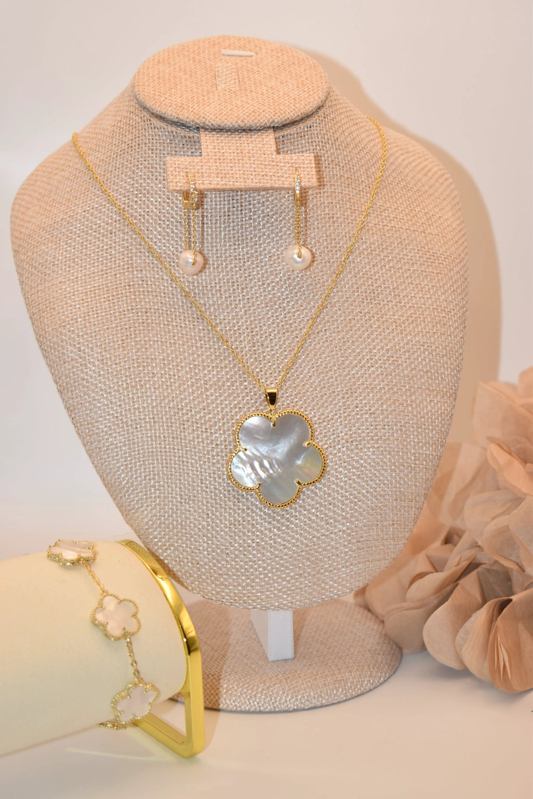 Tara Clover Necklace set: gold-tone necklace with a mother-of-pearl clover pendant and matching earrings and bracelet.