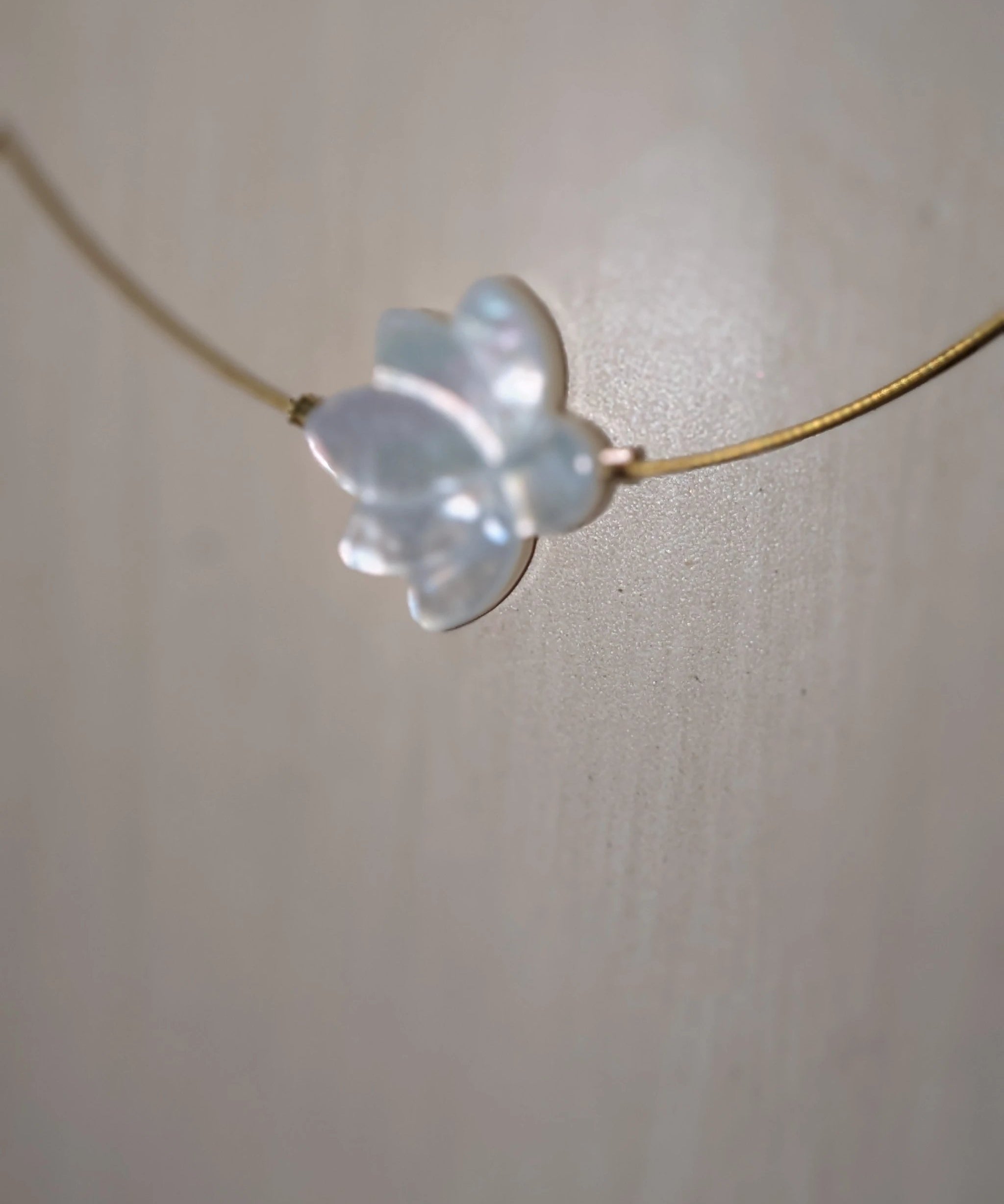 The White Lotus Necklace by Mar&Ella; gold chain with translucent lotus pendant