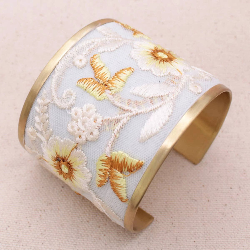 Wide pale blue fabric cuff with ivory floral embroidery, yellow butterfly accents, and gold-tone metal edges.