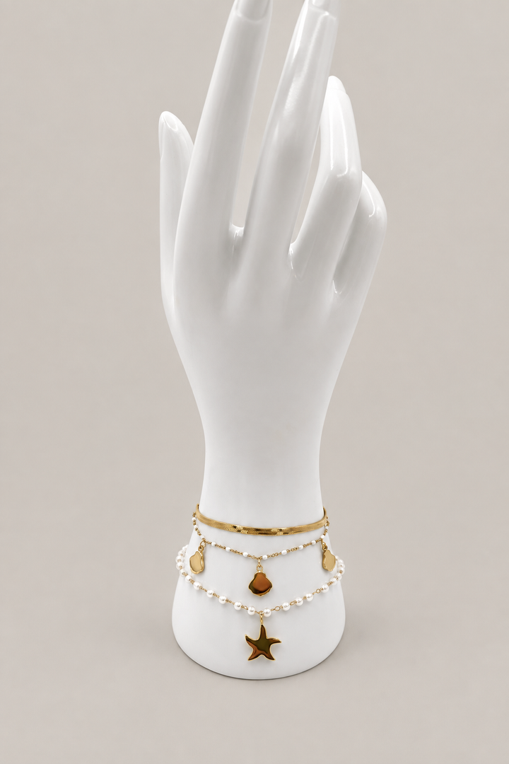 Cassis Shell Pearl Bracelet Set with a matching warm-gray background