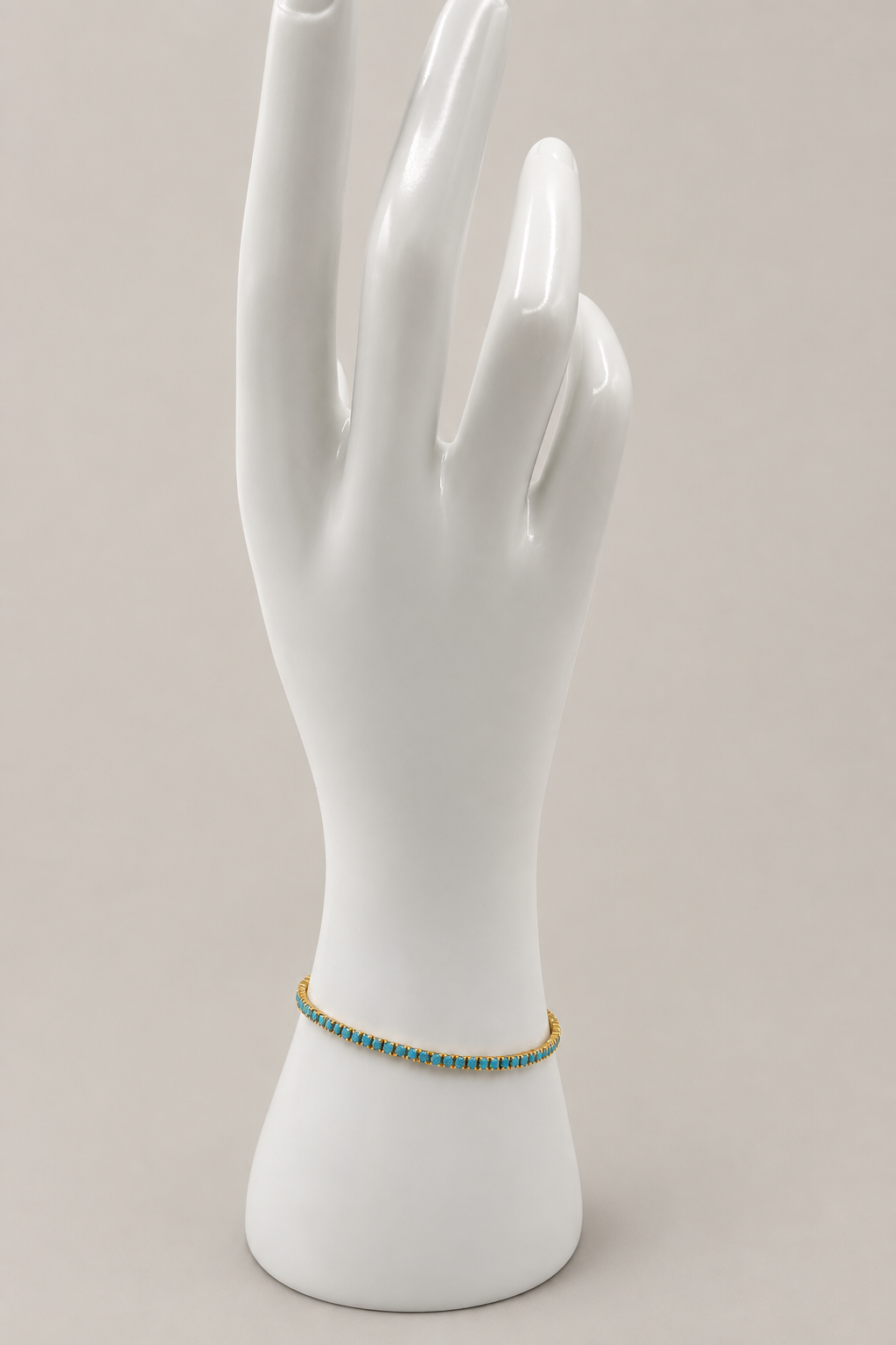 Chloe Tennis Bracelet in turquoise with a matching warm-gray background