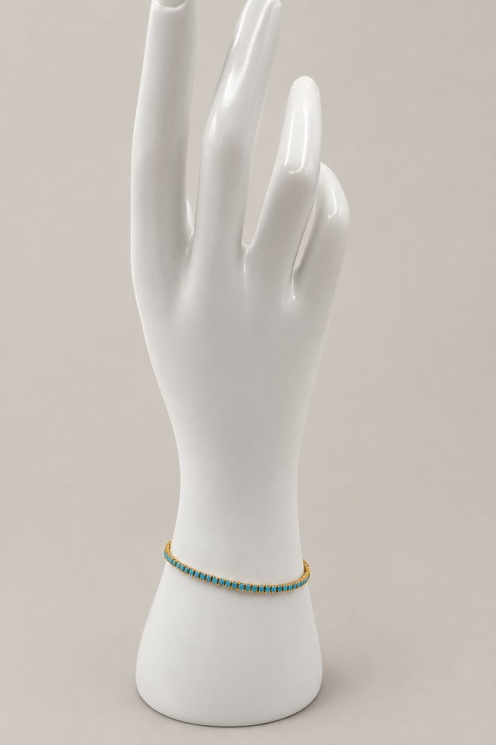 Chloe Tennis Bracelet in turquoise with a matching warm-gray background