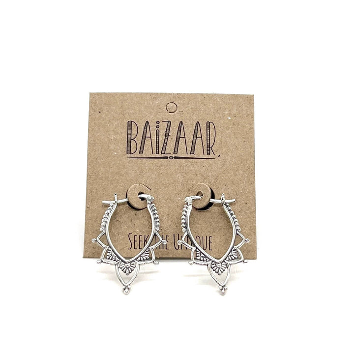 Pair of sterling silver lotus-inspired hoop earrings with beaded trim and petal accents on a brown kraft display card.