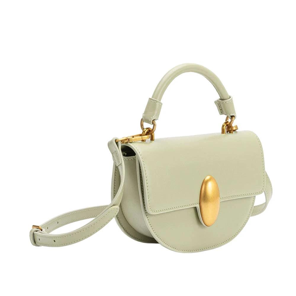 Mint green vegan leather crossbody bag with curved front flap, gold oval clasp, top handle and adjustable strap