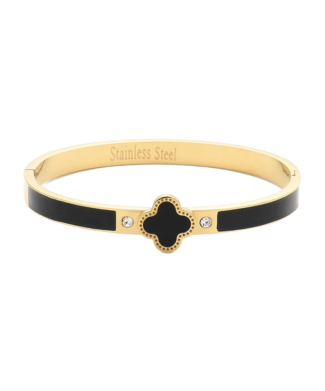Gold-tone bangle with black enamel side panels and a central black four-leaf clover charm with a dotted gold border.
