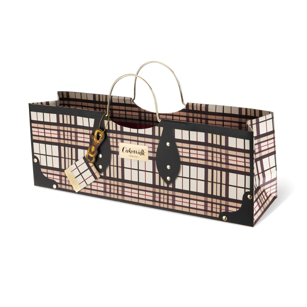 Long plaid wine bag with gold handles, black corner patches, and a plaid charm tag.