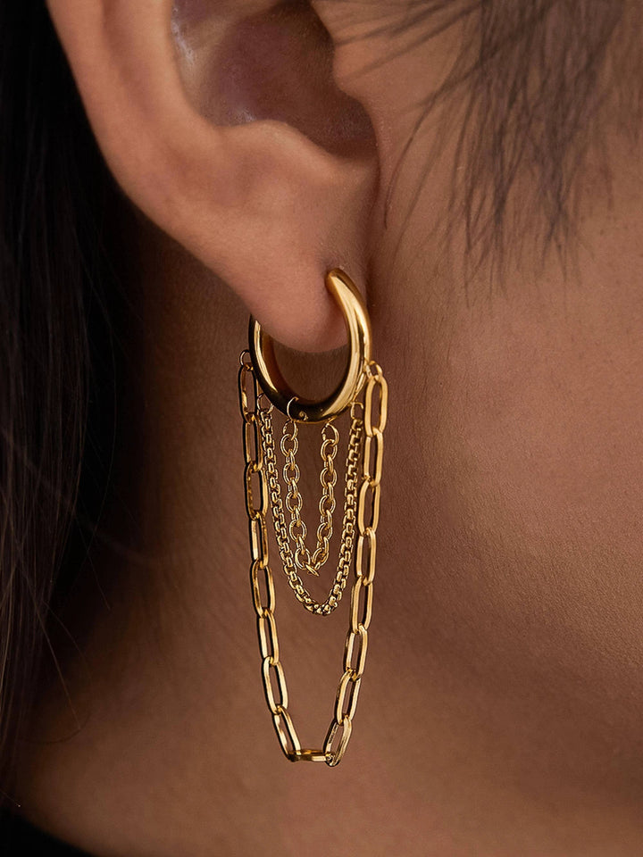18K gold hoop earring with layered cascading chains of varying widths hanging from the hoop