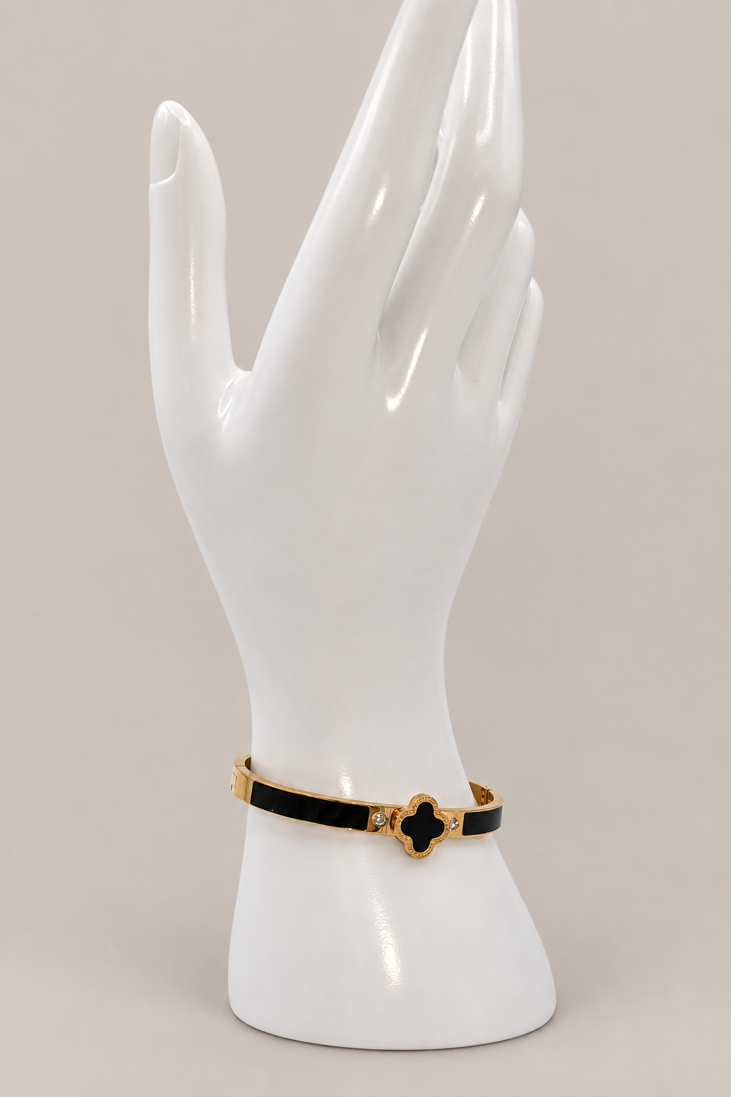 Enamel Clover Bangle with a matching warm-gray background