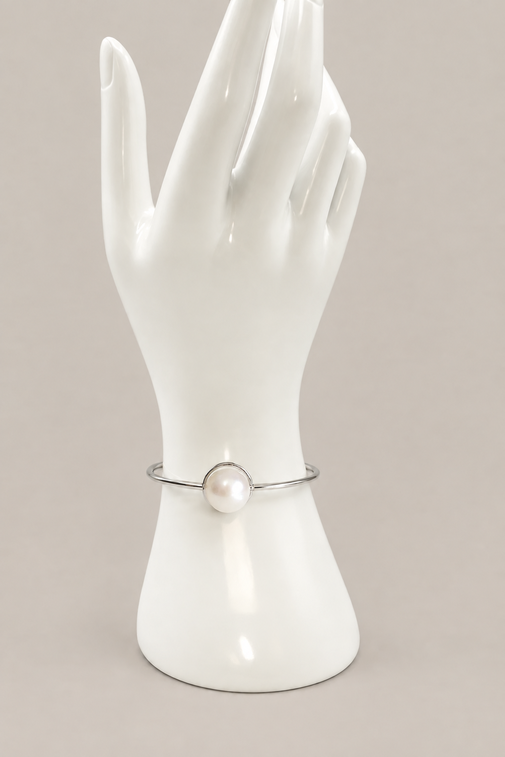 Freshwater pearl bracelet on a matching white display hand