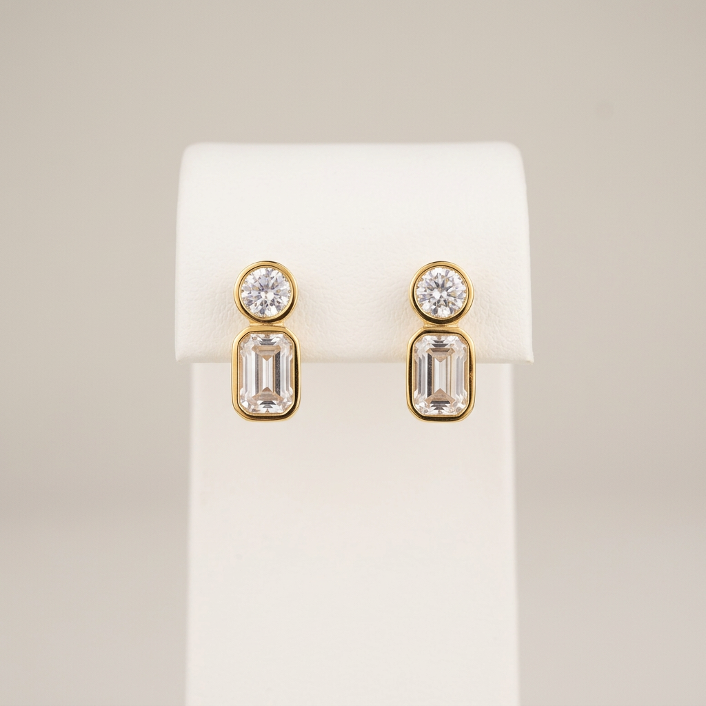 Gold CZ studs on a white display stand