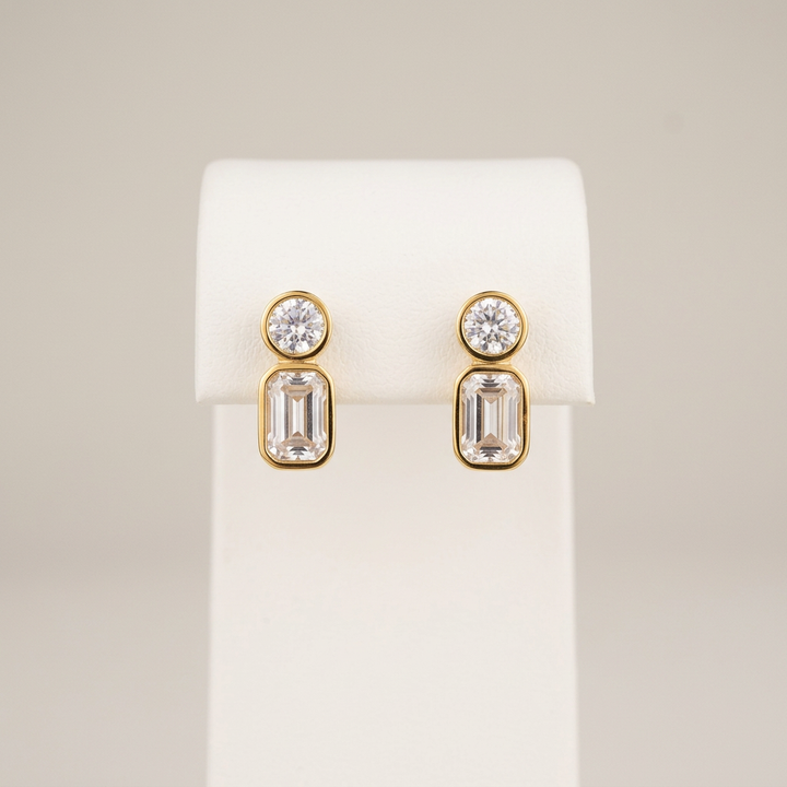 Gold CZ studs on a white display stand