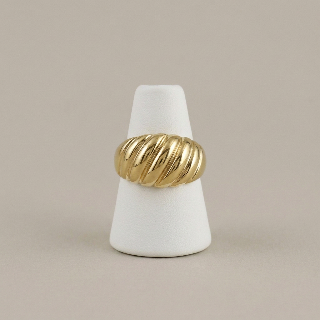 Gold dome ring on the matching white ring holder