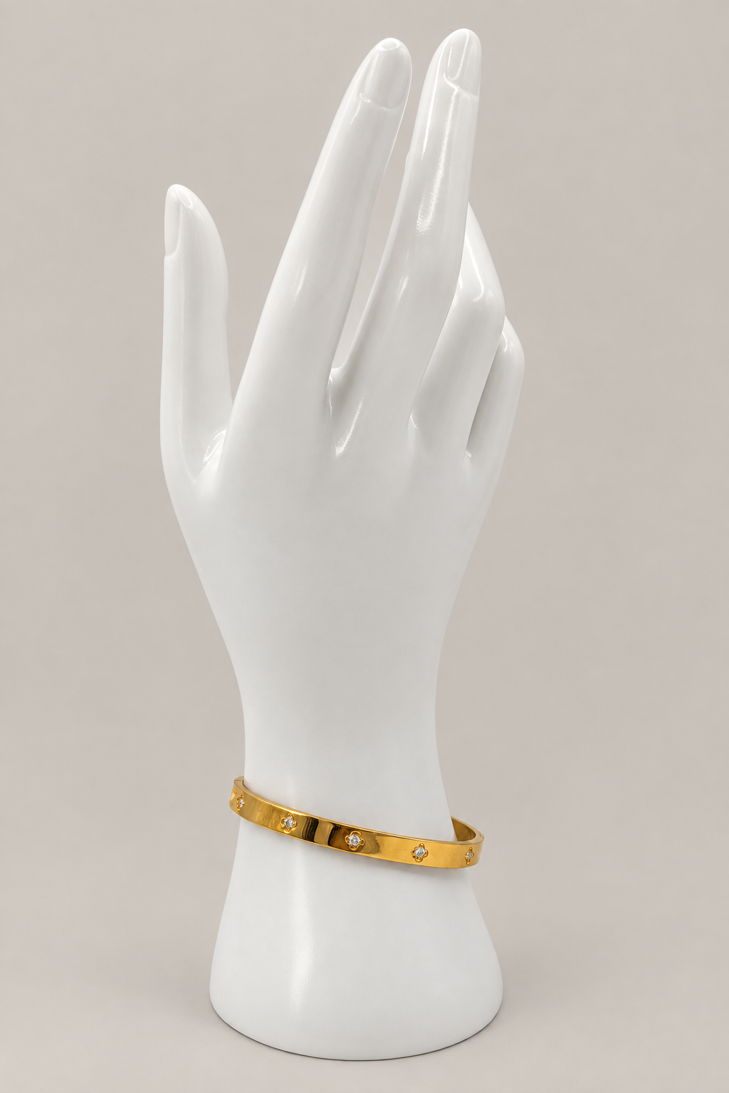 Gold Flower Bangle with a matching warm-gray background