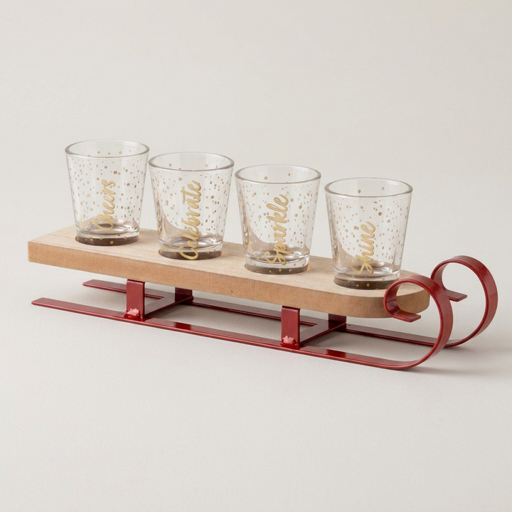 Holiday sleigh shot glass set on a soft warm-gray background