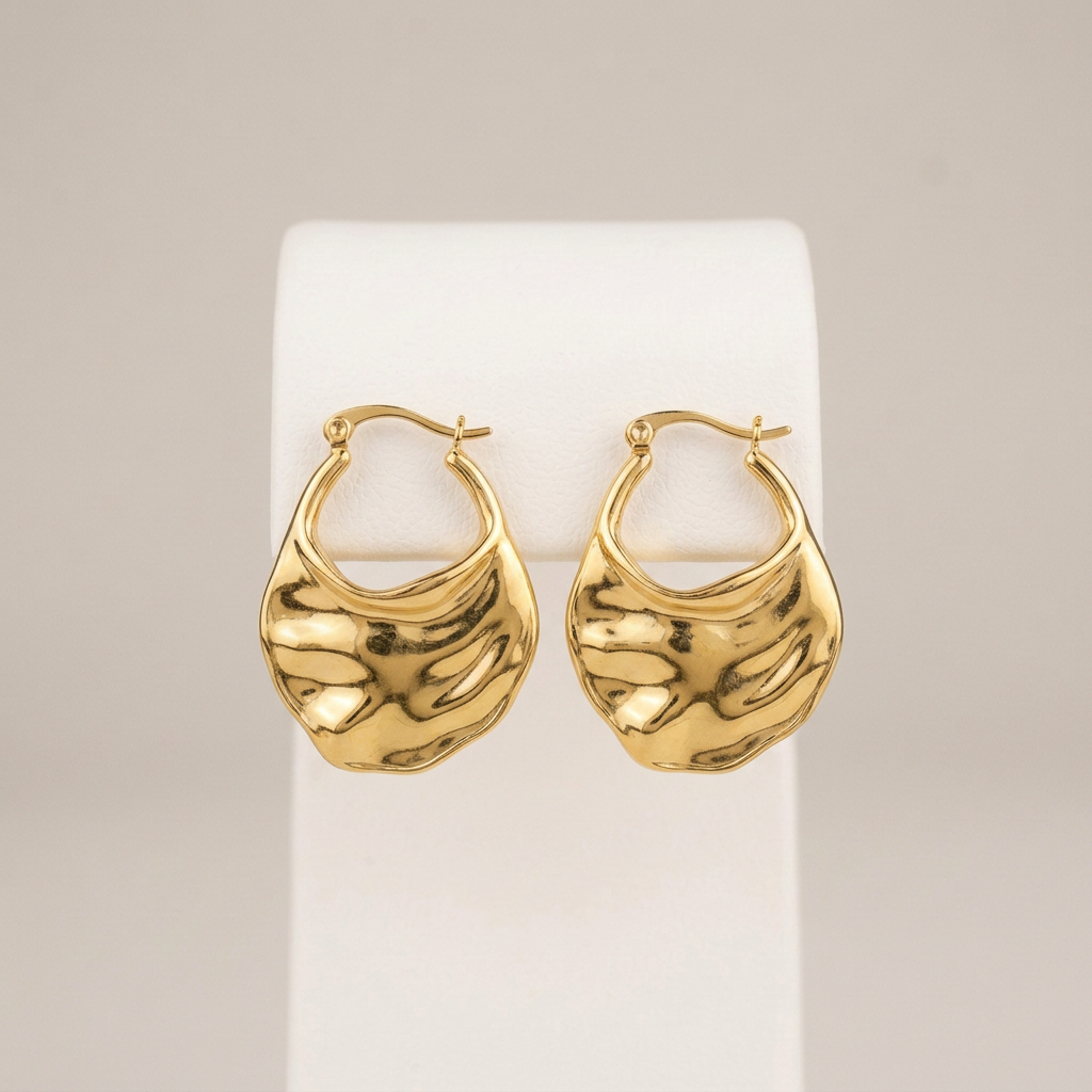 Jinni gold hoops on the matching white stand