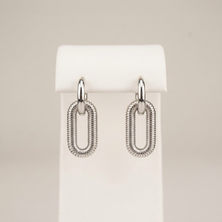 Kate earrings on the original matching white stand