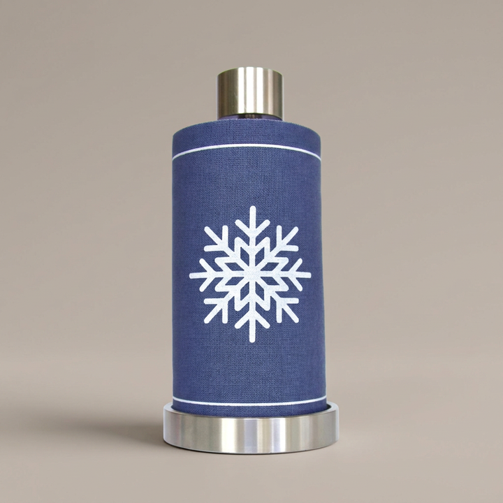 Let it Snow napkin roll on its silver stand with a plain warm greige background