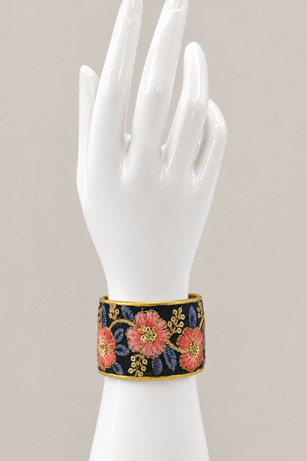 Main-photo embroidered cuff on an upright white hand