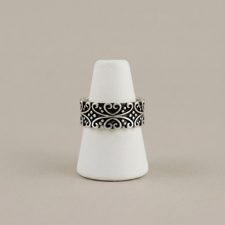 Oxidized silver band on the matching white cone stand