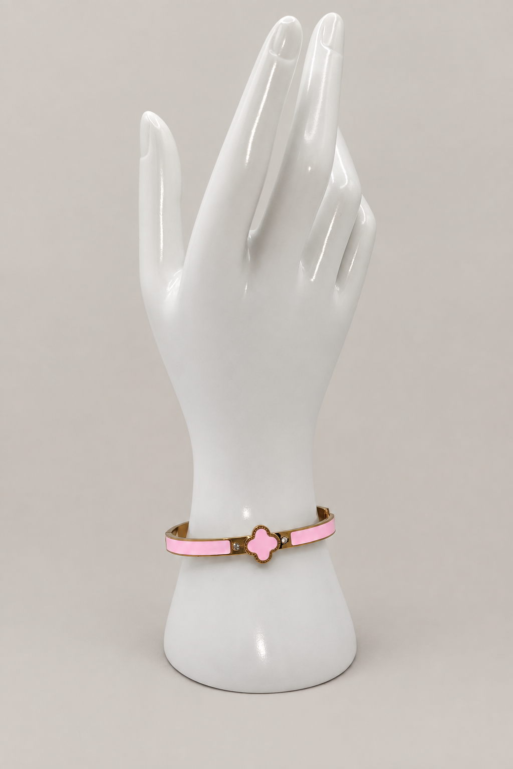 Pink Enamel Clover Bangle with a matching warm-gray background