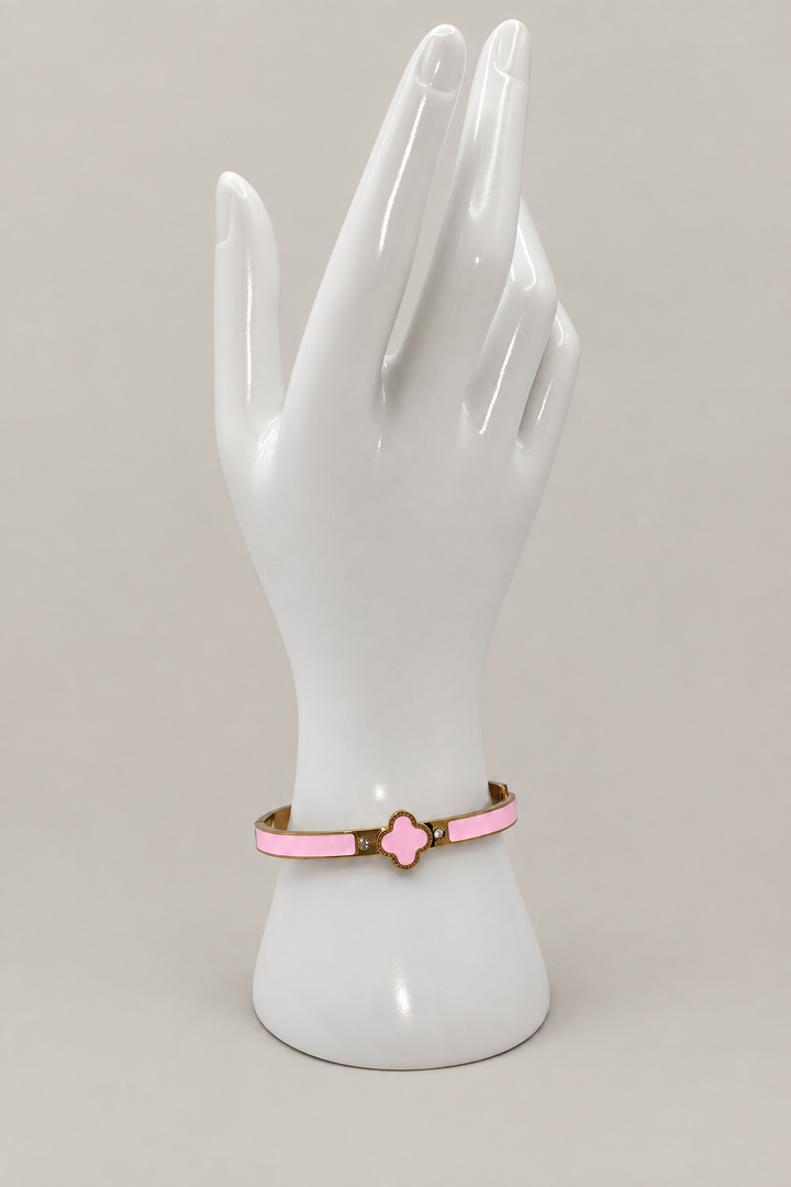 Pink Enamel Clover Bangle with a matching warm-gray background