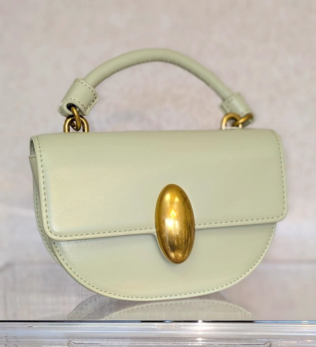 Melie Bianco Esther Mint recycled vegan leather crossbody bag in mint green with a gold oval clasp