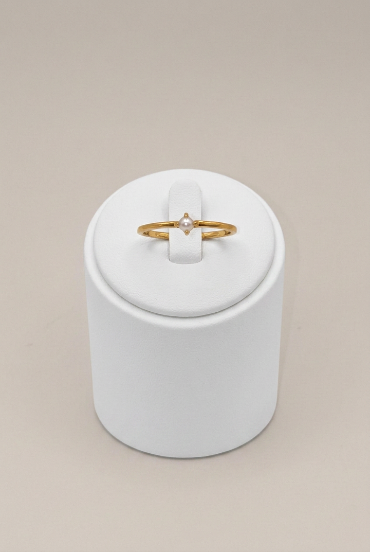 Solo Pearl Ring with a brighter white stand and light warm-gray background