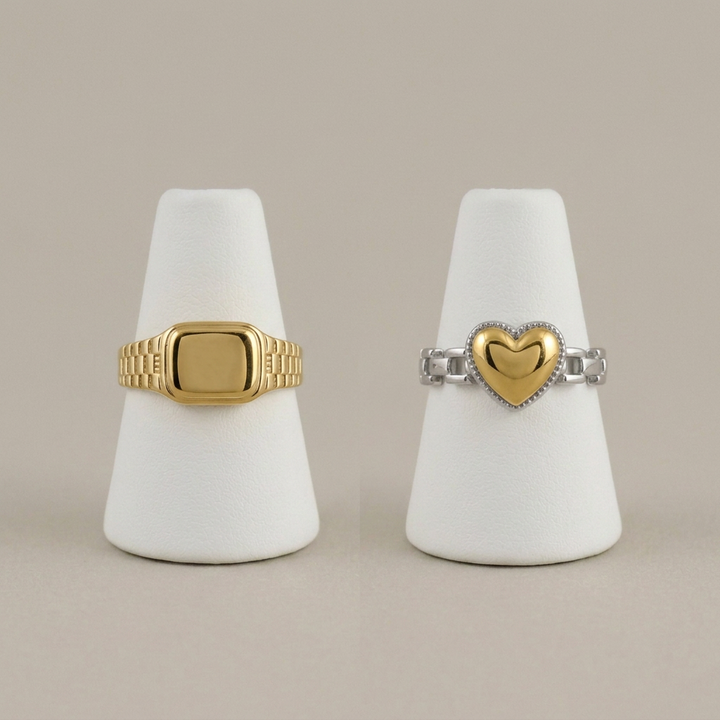 Square and heart rings on matching white stands