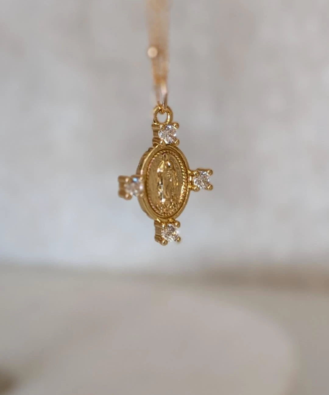 Camila Cross Necklace by True by Kristy Jewelry, 14k gold pendant with round medallion and four clear stones.