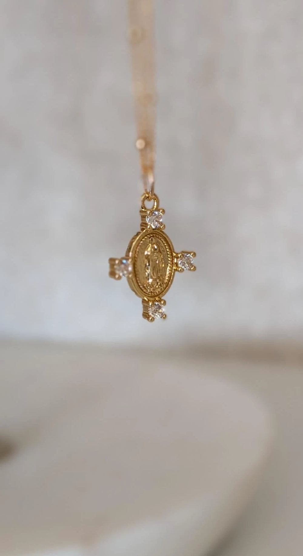 Camila Cross Necklace by True by Kristy Jewelry, 14k gold pendant with round medallion and four clear stones.