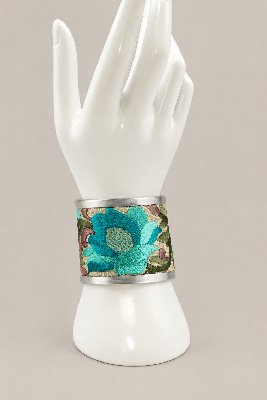 Turquoise floral cuff on a Stevie-style white display hand