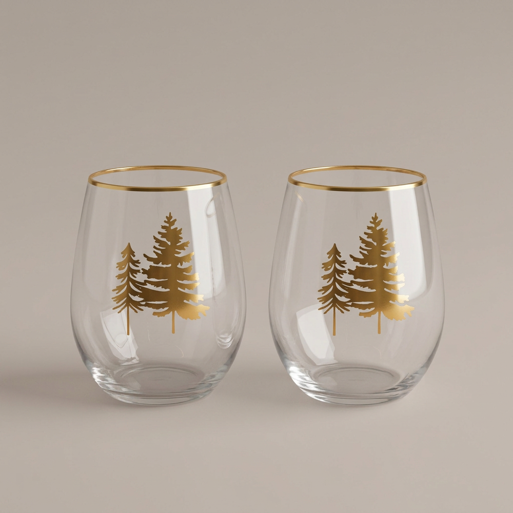 Two gold-tree stemless wine glasses on a plain warm-gray background, without packaging
